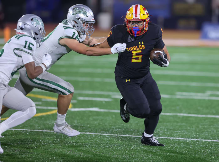 Mission Viejo's Hinesward Lilomaiava is grabbed by De La Salle's Drew Cunningham.